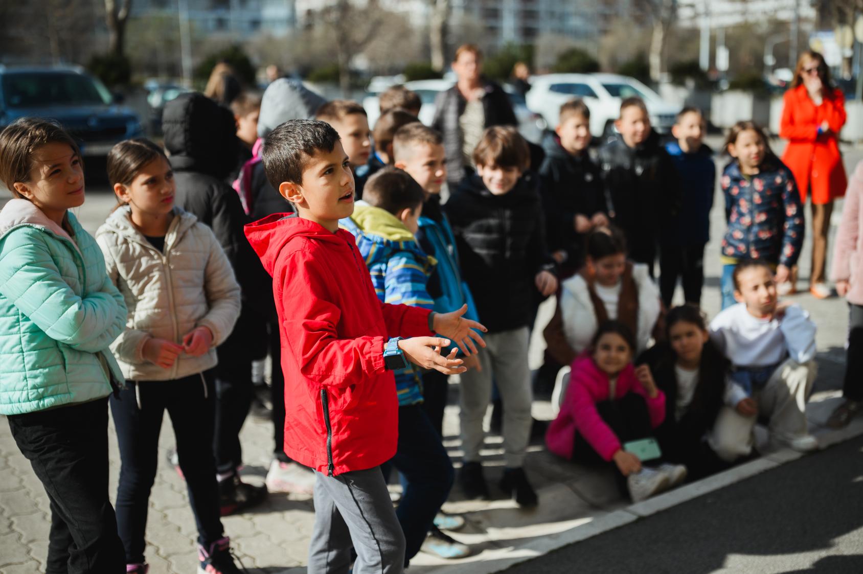 A group of young children talking to the camera
