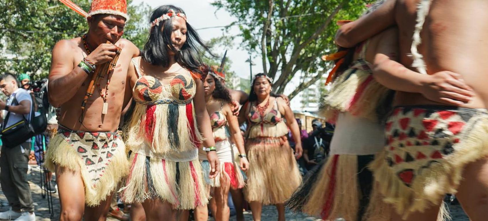 A group of people wearing traditional dress and performing