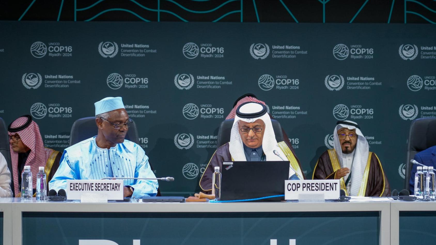 A group of people wearing traditional dress at the opening of COP16 