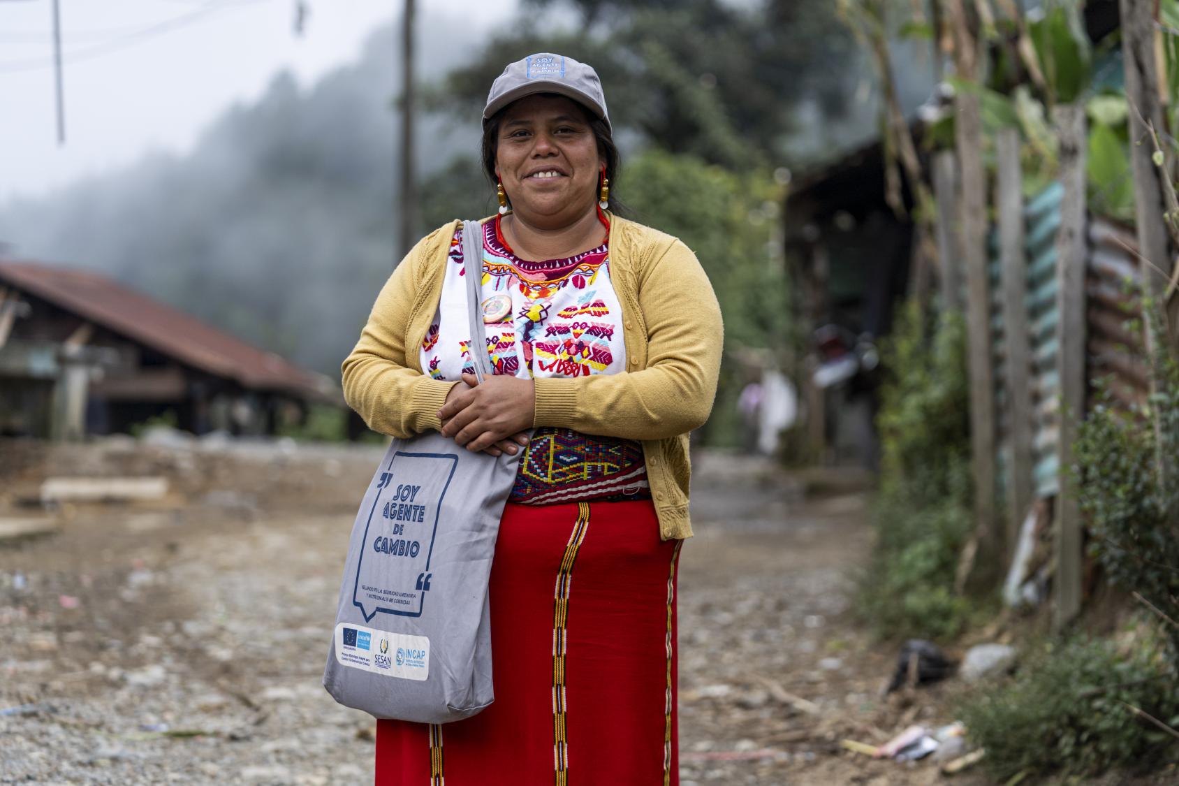 A woman looks at the camera and smiles