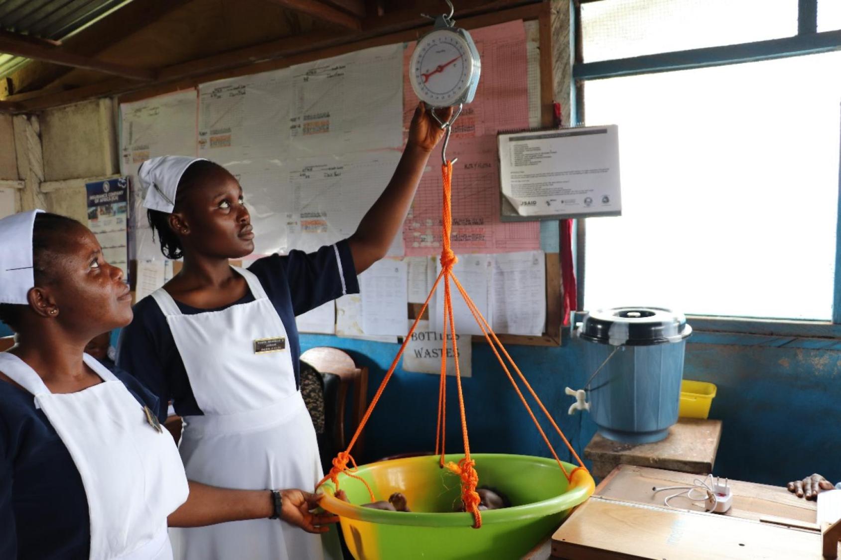 Two women working on a scale