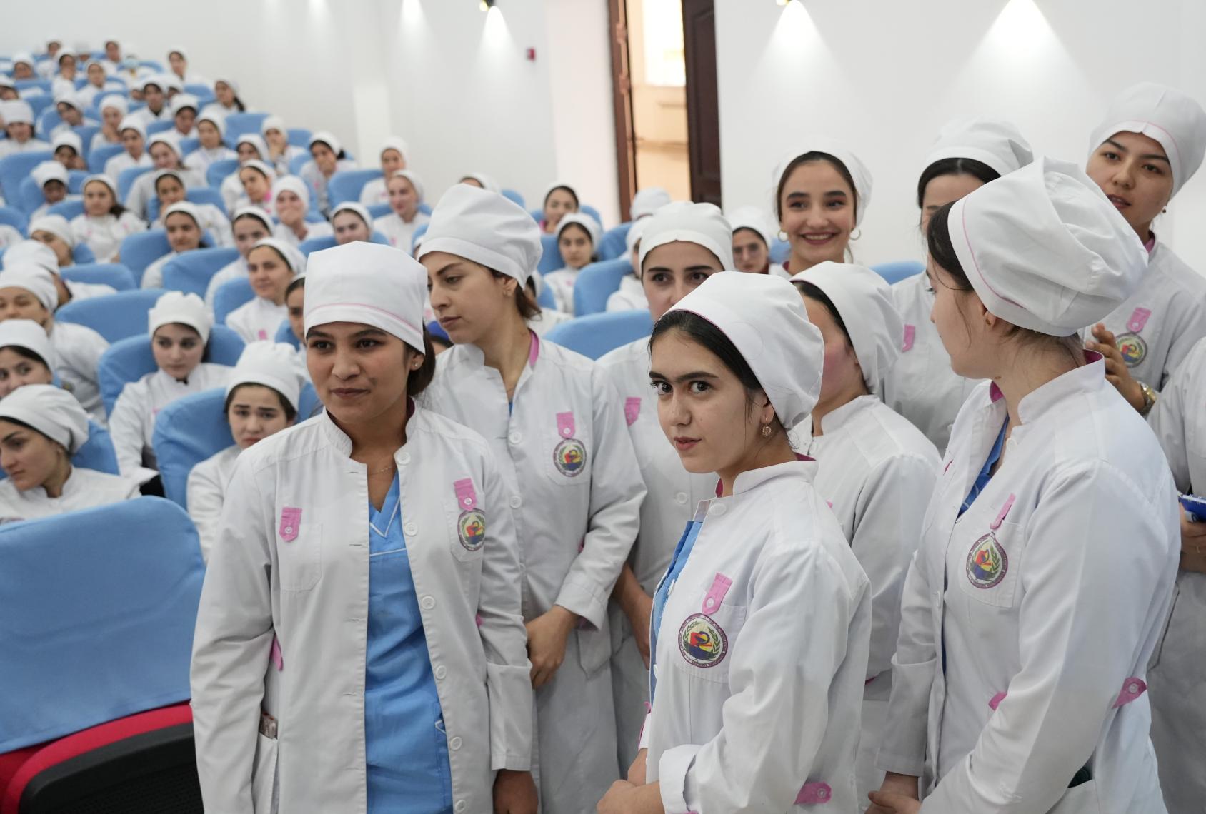 A group of women looking at the camera they are all wearing a certain uniform 