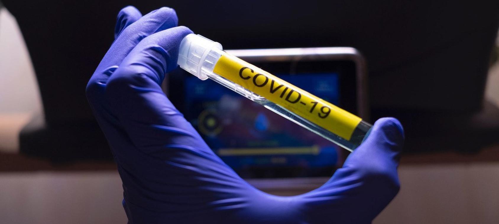 An injection with the words COVID-19