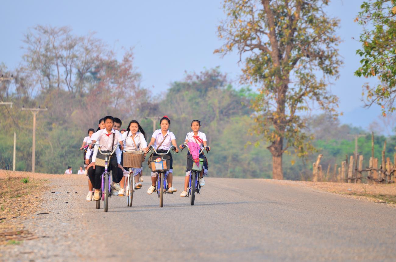 group of children cycle along a road 