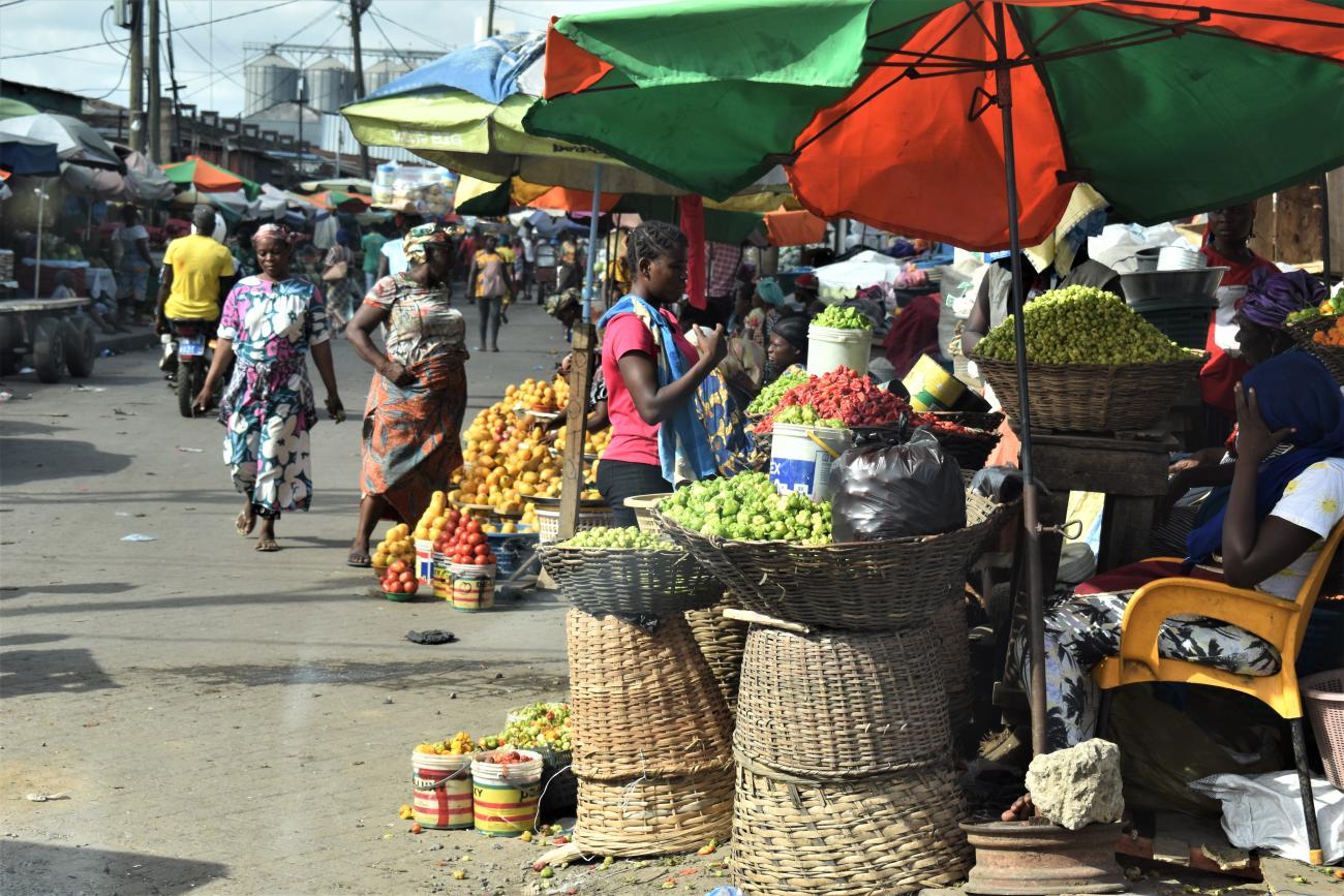 busy market with people selling fruit and vegetables 