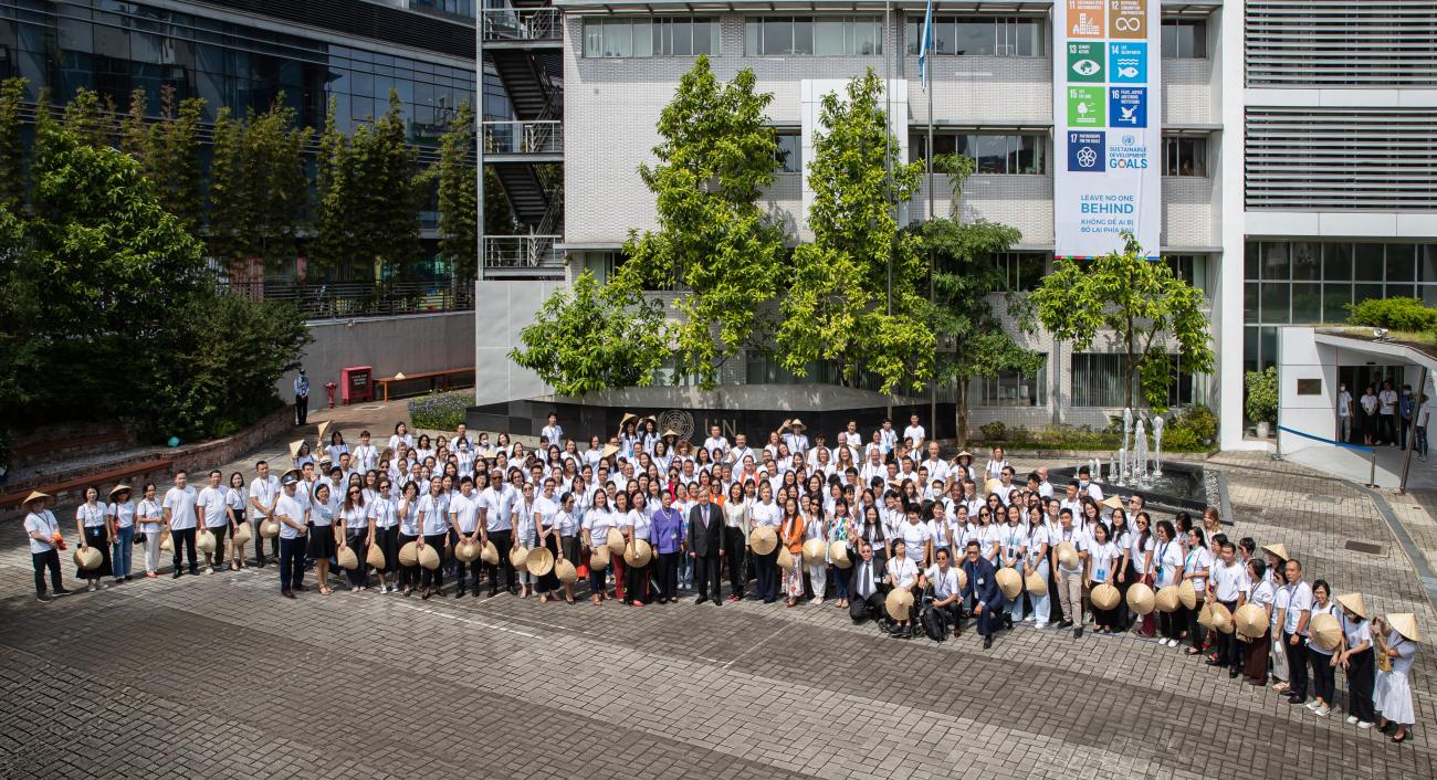 photo from above of large group of people standing outside a building