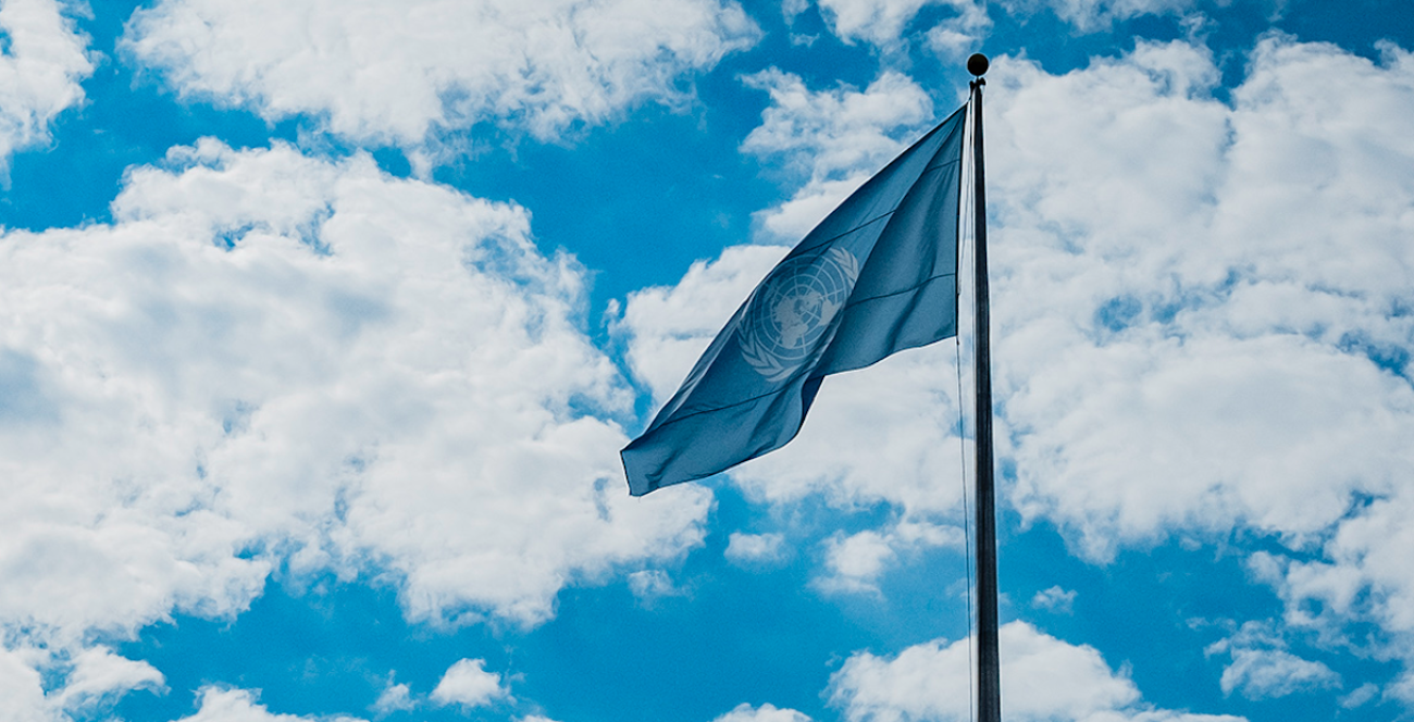 UN flag against cloudy sky 