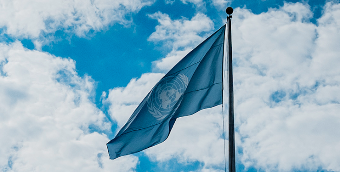 UN flag against cloudy sky 