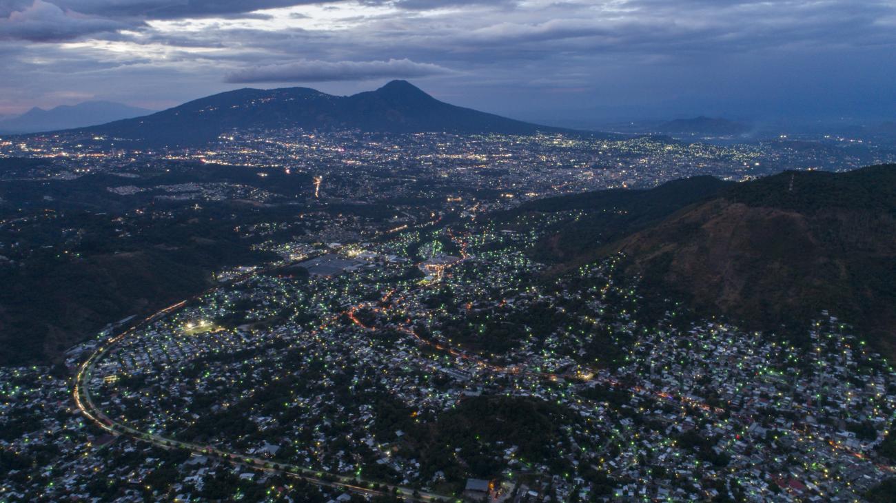 Aerial view of a cityscape in El Salvador during the evening
