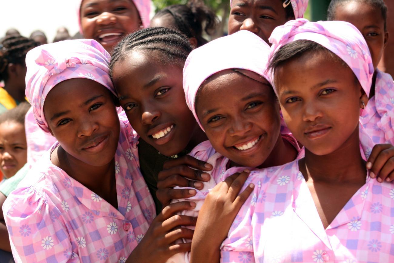 A picture of four girls in pink dresses