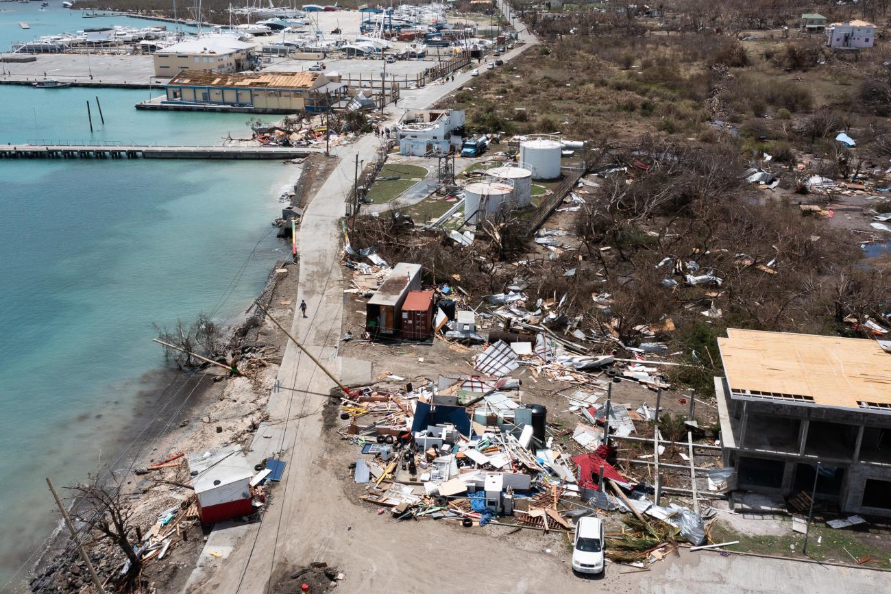 A devastating scene by the waterfront, showing houses and buildings damaged