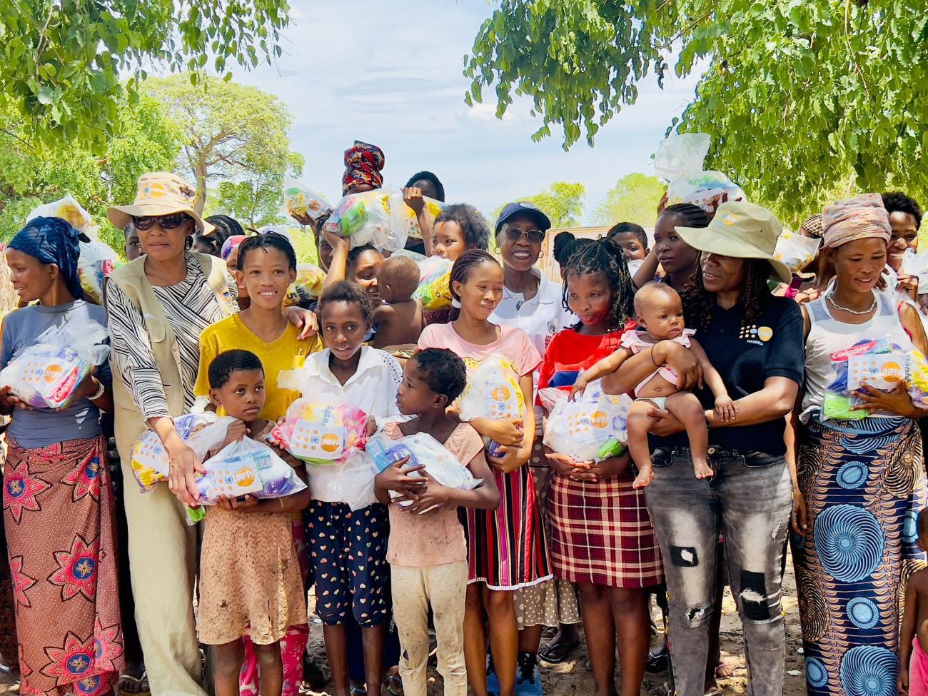 A group of people standing outdoors holding children