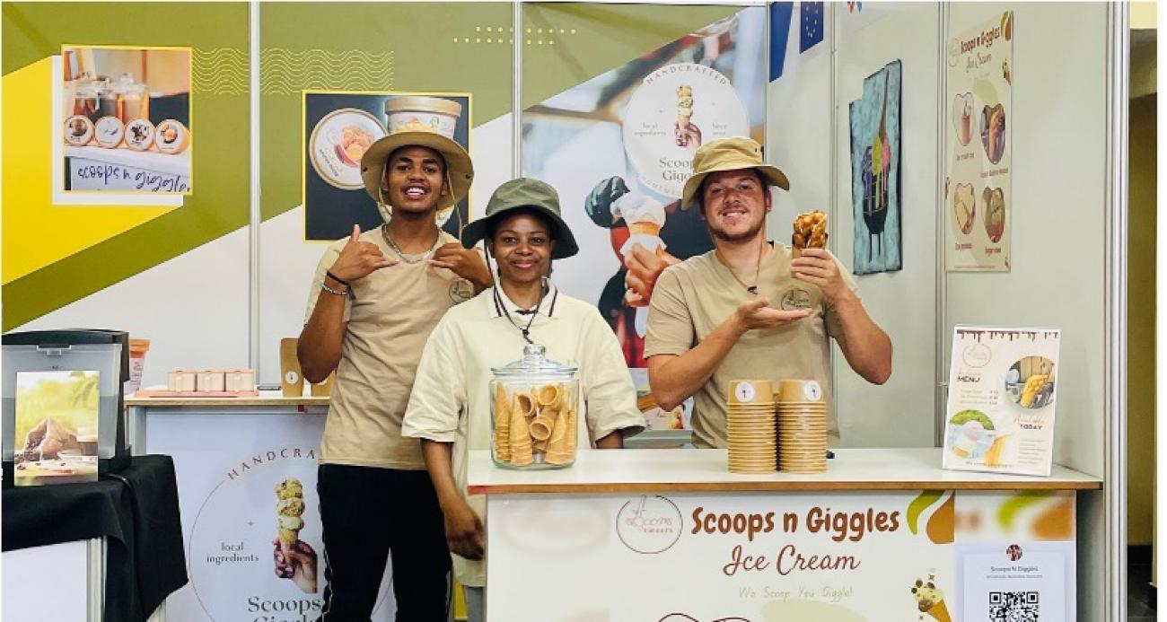 Employees of a local ice-cream store happily pose for a photo.