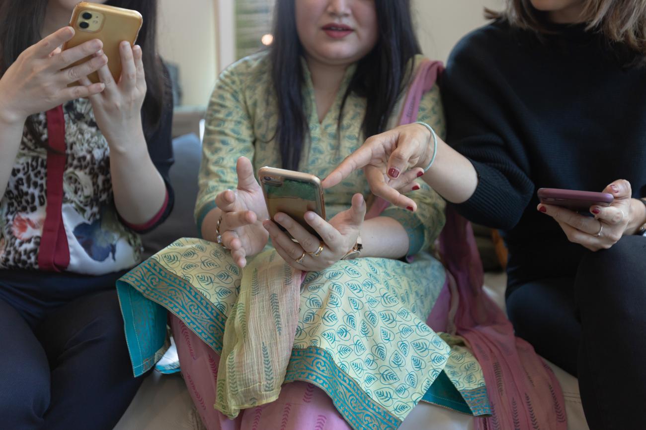 Three women using smartphones.
