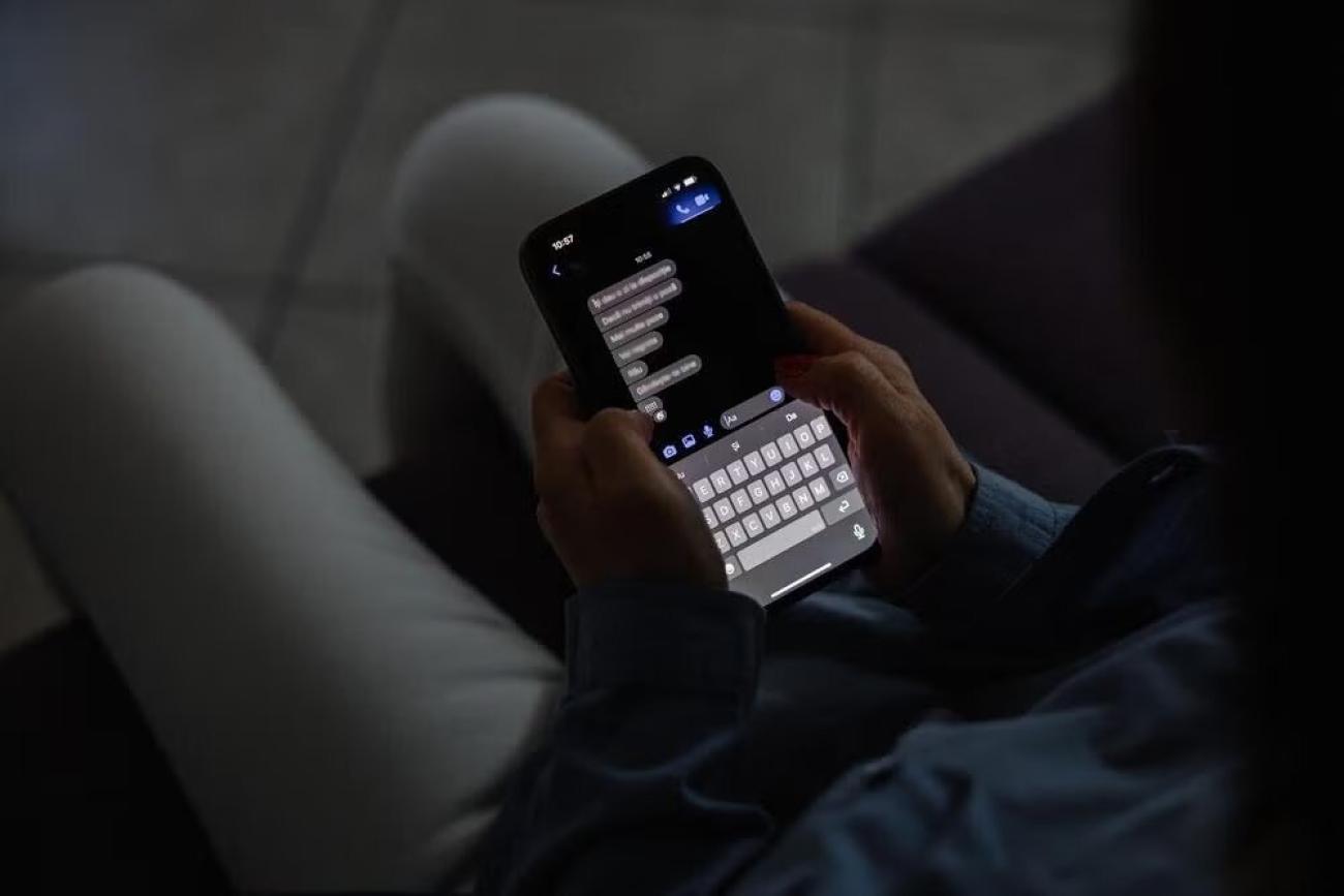 A girl reads messages on her phone.