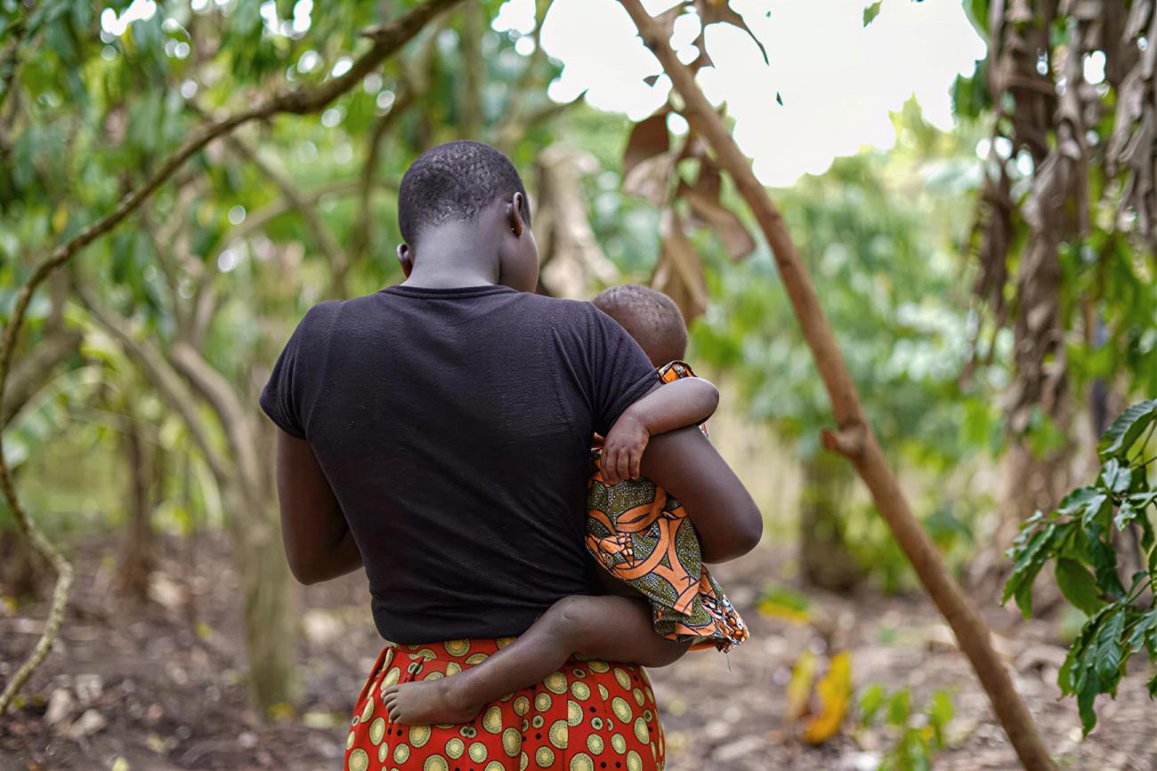 A woman carries her child.