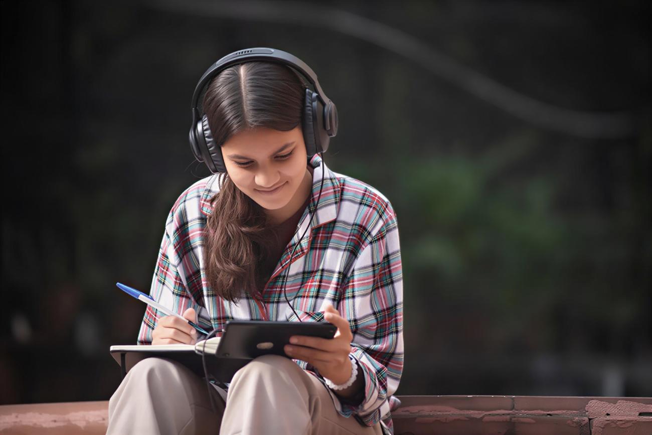 A girl watches a video on her phone.