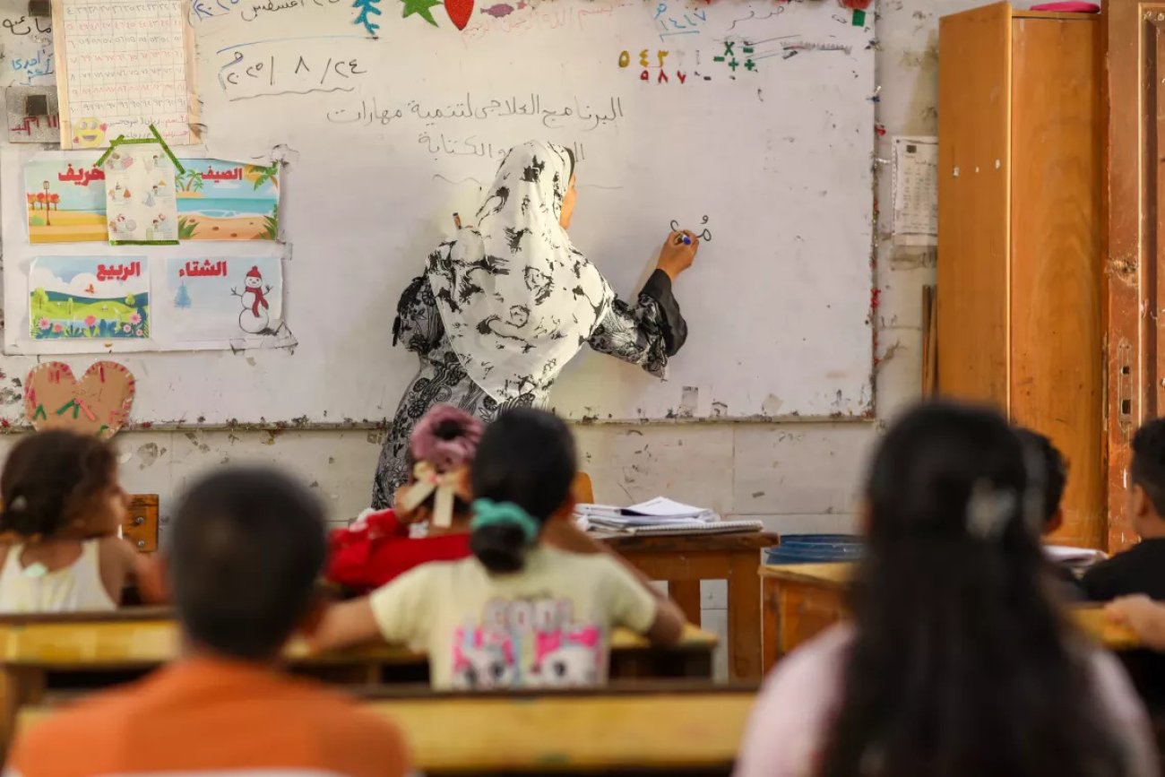 Students in a classroom listen to a teacher in Egypt.