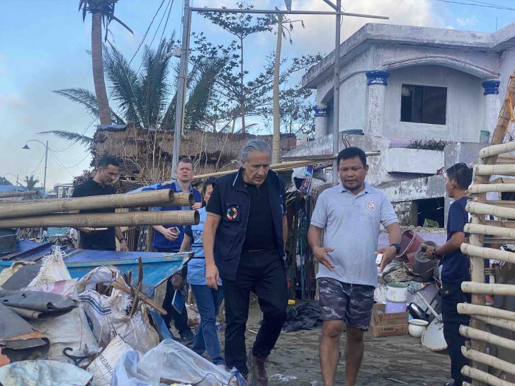 The RC walks in an area with construction being led by a community leader 