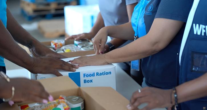 Humanitarians package food ration kits after a hurricane in Jamaica.