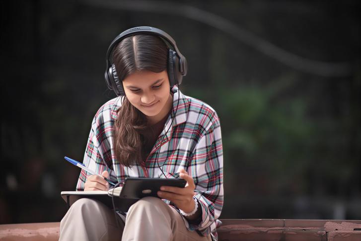 A girl watches a video on her phone.