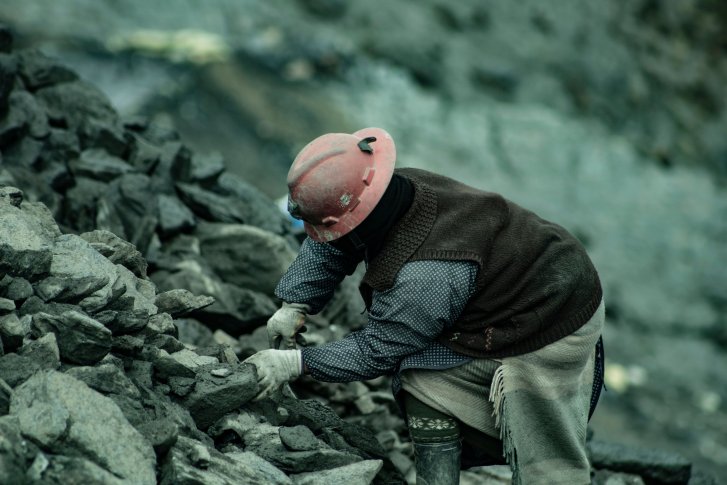 A miner harvesting coal.