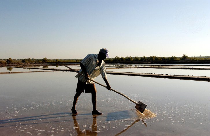 A man processes salt in Mozambique.