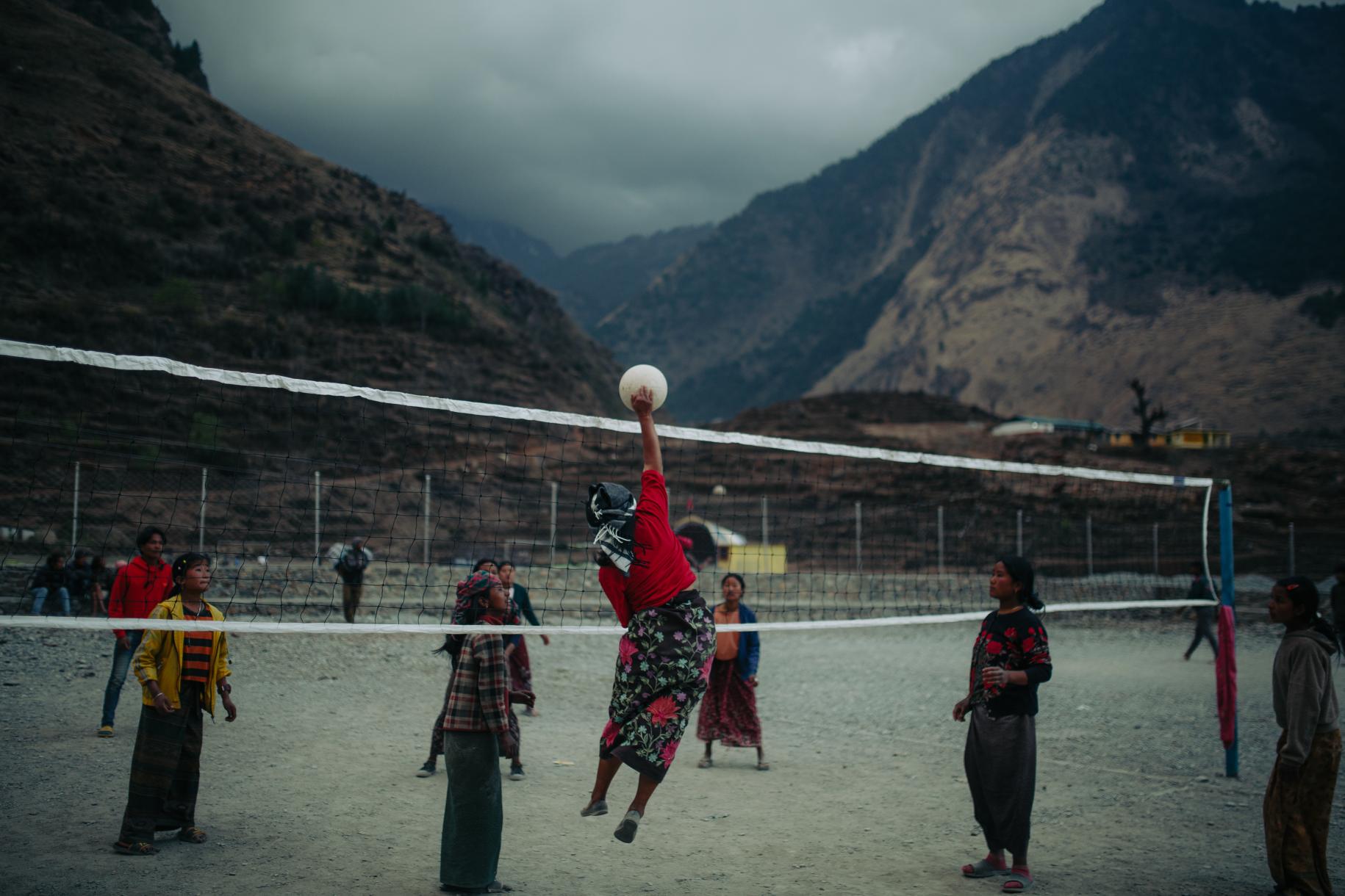 group of women play volleyball outside 
