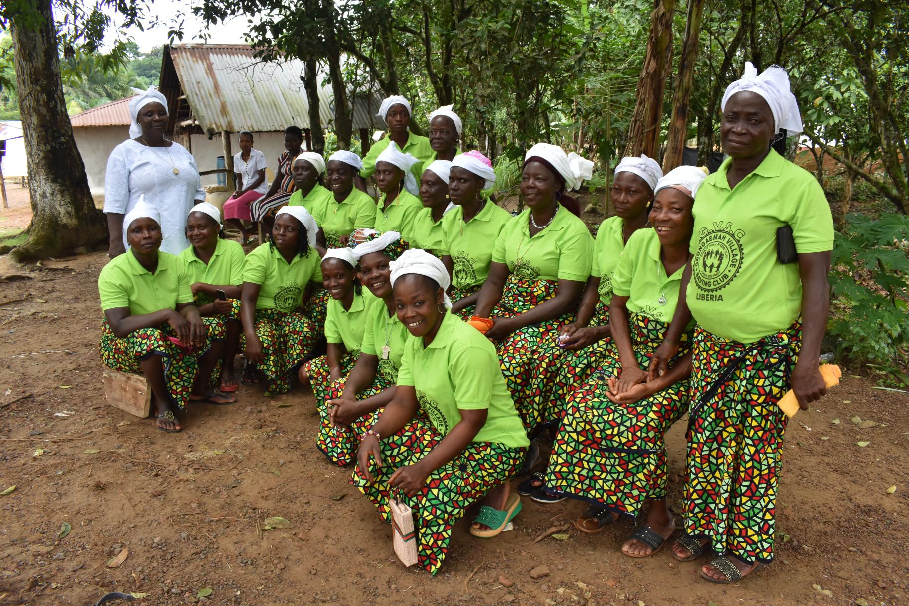group of women in green tops and white head scarves 