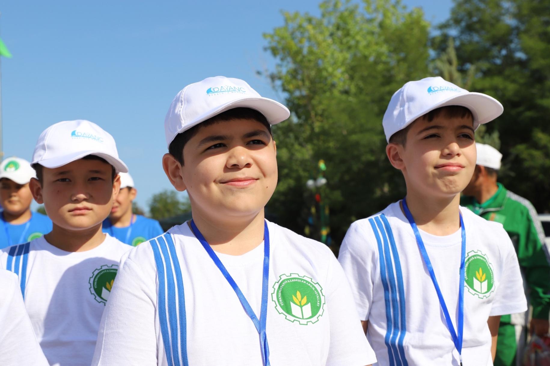 young boys stand in white gaps outside 