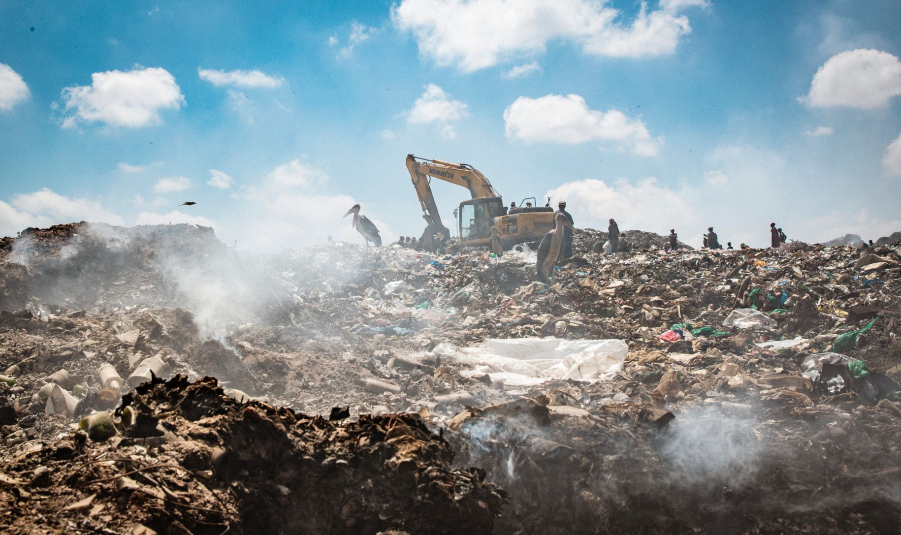 polluted waste site with smokes fumes rising into the sky 