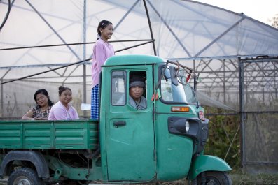 Family inside a blue tuk tuk.